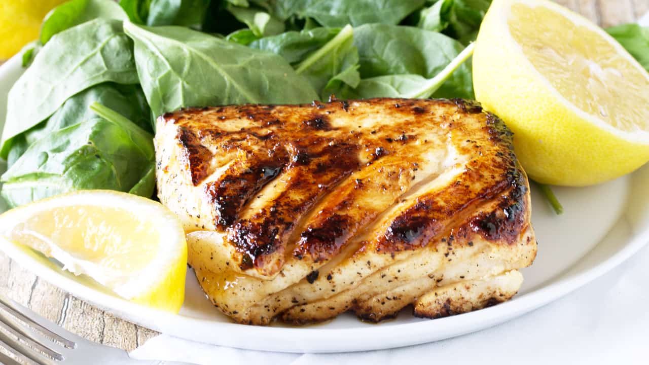 Enjoy a healthy and delicious meal ready in just minutes! Easy and delicious grilled halibut with honey and lemon will have you falling in love with fish for the first time, or all over again!