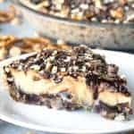 A salty pretzel crust layered with gooey hot fudge, a silky and creamy peanut butter custard for the filling and topped with curls of chocolate, chocolate fudge and crushed pretzels.