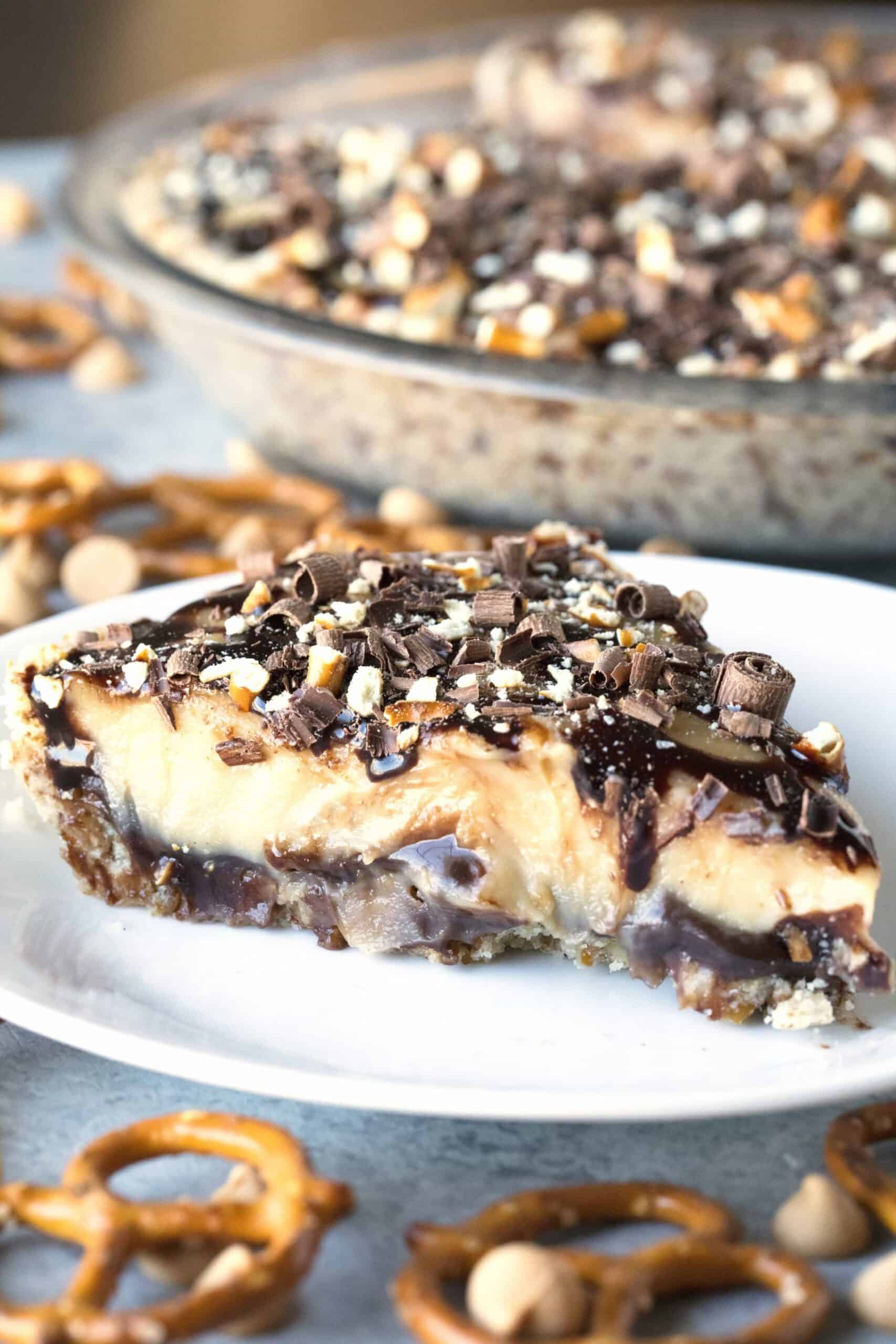 A salty pretzel crust layered with gooey hot fudge, a silky and creamy peanut butter custard for the filling and topped with curls of chocolate, chocolate fudge and crushed pretzels.