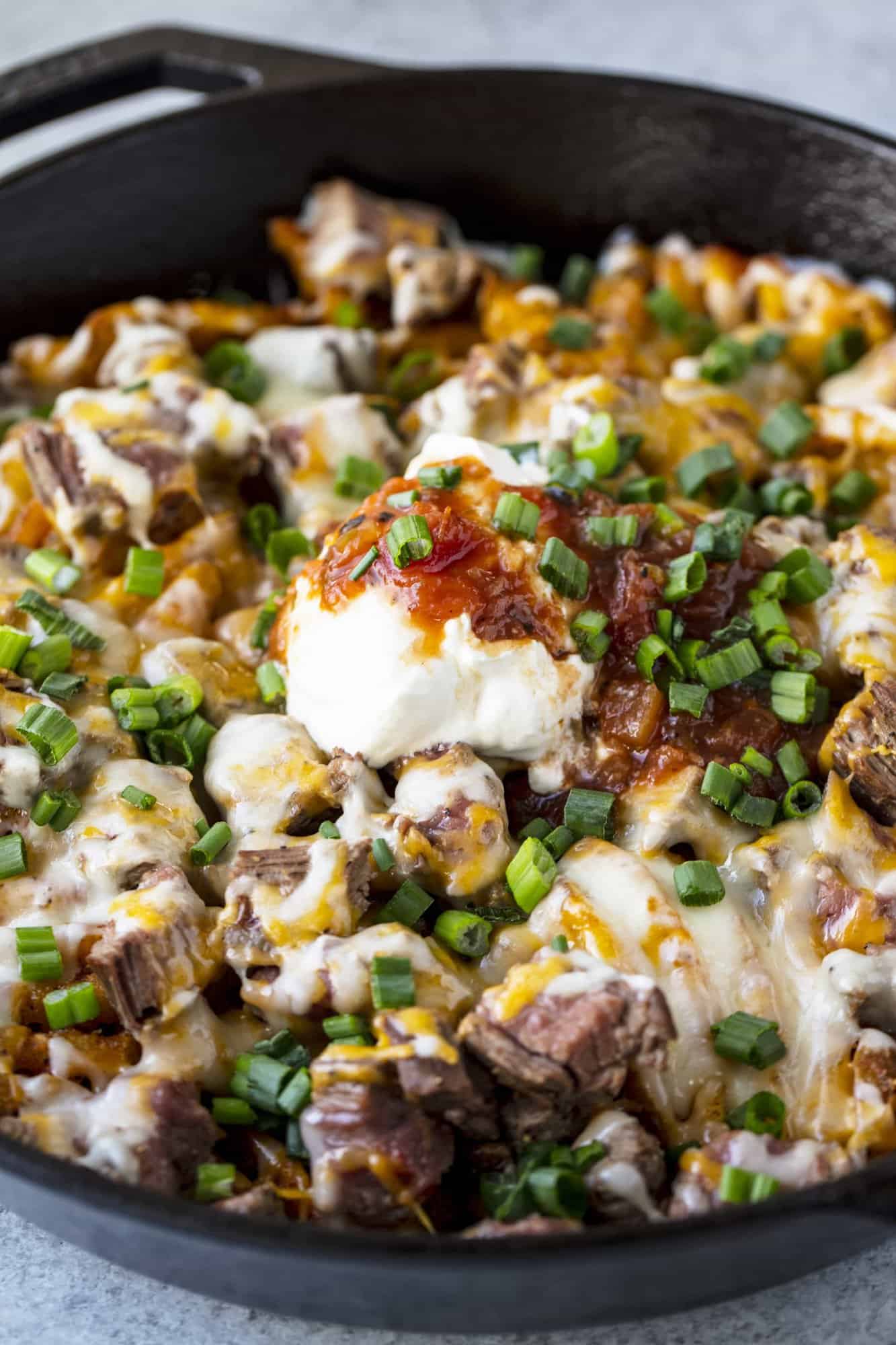 Steak and Potato Nachos combine three of your favorite comfort foods into one amazing and indulgent skillet dish. Eat it as a drool-worthy appetizer, or as a hearty and full dinner.