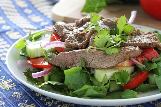 Close up of Thai Beef Salad on a white plate.