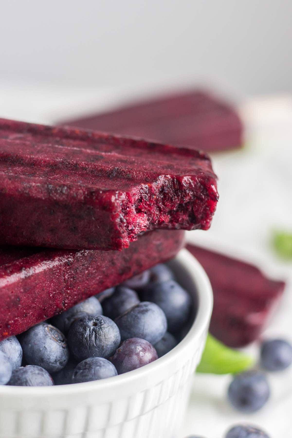 Healthy, 3-ingredient blueberry basil popsicles are the perfect easy and healthy treat! They take less than 15 minutes to make and freeze in a couple hours. Your family and friends will be amazed that they’re made with whole foods and taste so delicious and sweet!