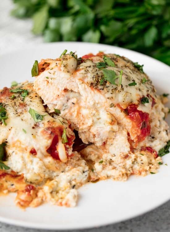 Lasagna Stuffed Chicken is all the flavors you love from lasagna stuffed inside a chicken breast and it's smothered in cheesy, saucy goodness. What's not to love?