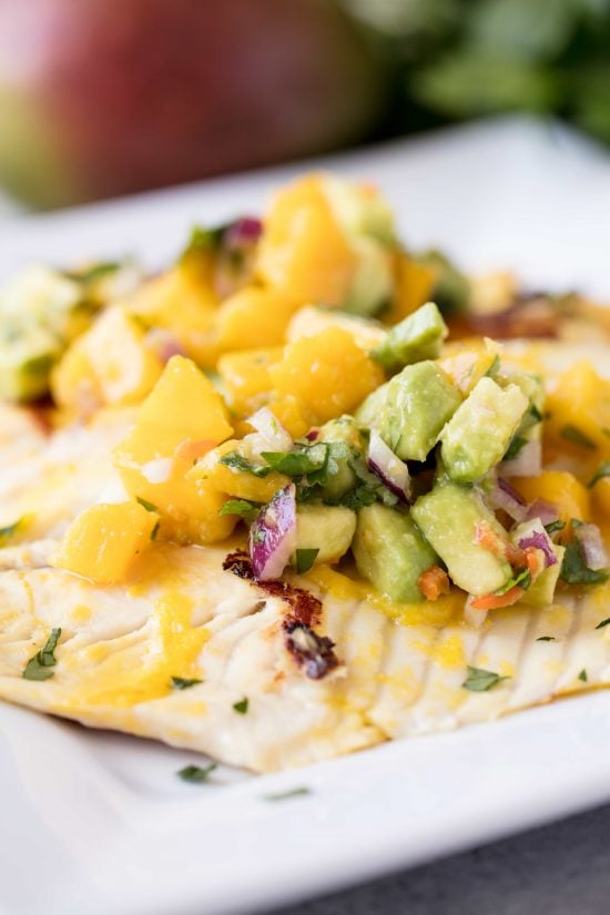 Close up of Mango Chile Tilapia topped with mango avocado salsa. 