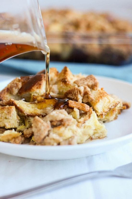 Syrup is poured on a plate of cinnamon toast crunch breakfast casserole