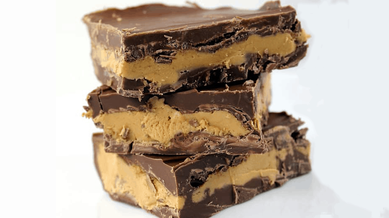 A stack of 3 chocolate peanut butter bars on a white background