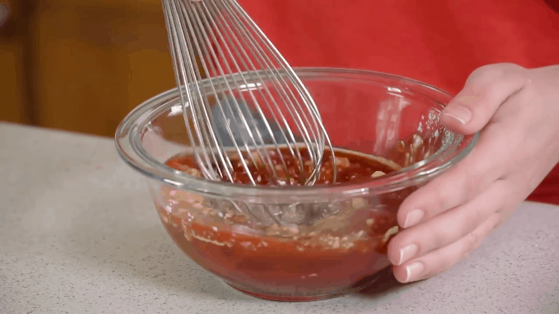 Honey Garlic BBQ Sauce being whisked in a bowl