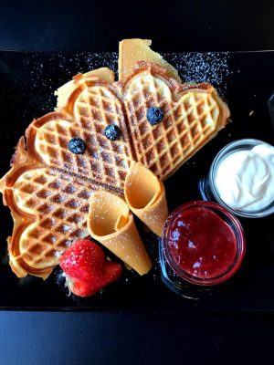 Norwegian Waffles at Nilsen Spiceri in Oslo, Norway with brown cheese, sour cream, and jam