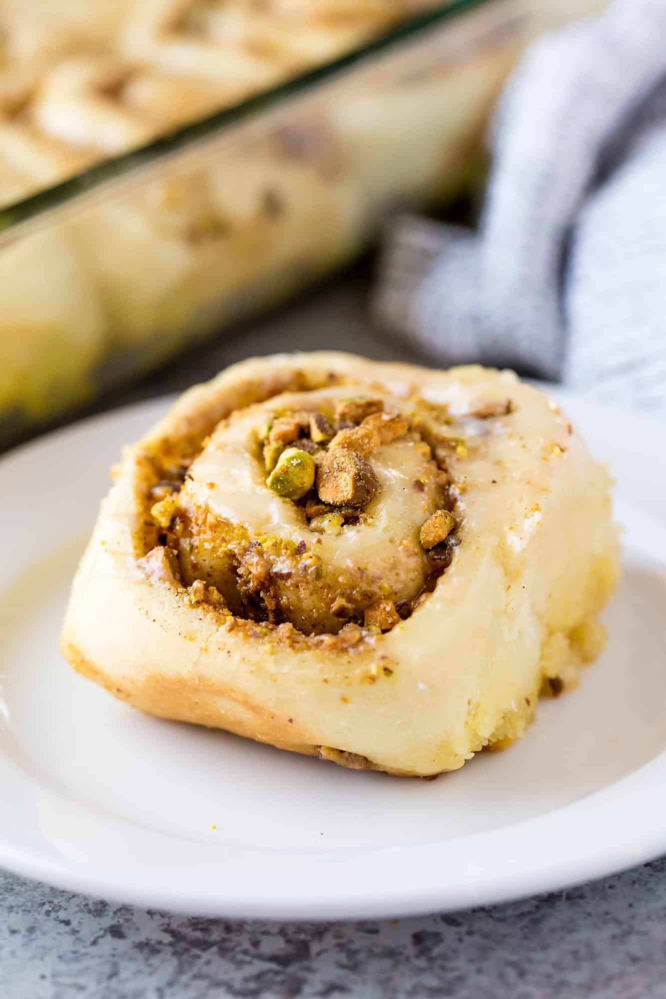 A freshly baked Baklava Cinnamon Roll served on a white plate