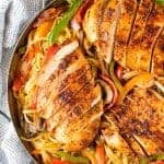 Cajun spiced chicken breasts sliced and served on a bed of linguini with grilled bell peppers, mushrooms and red onion in a skillet