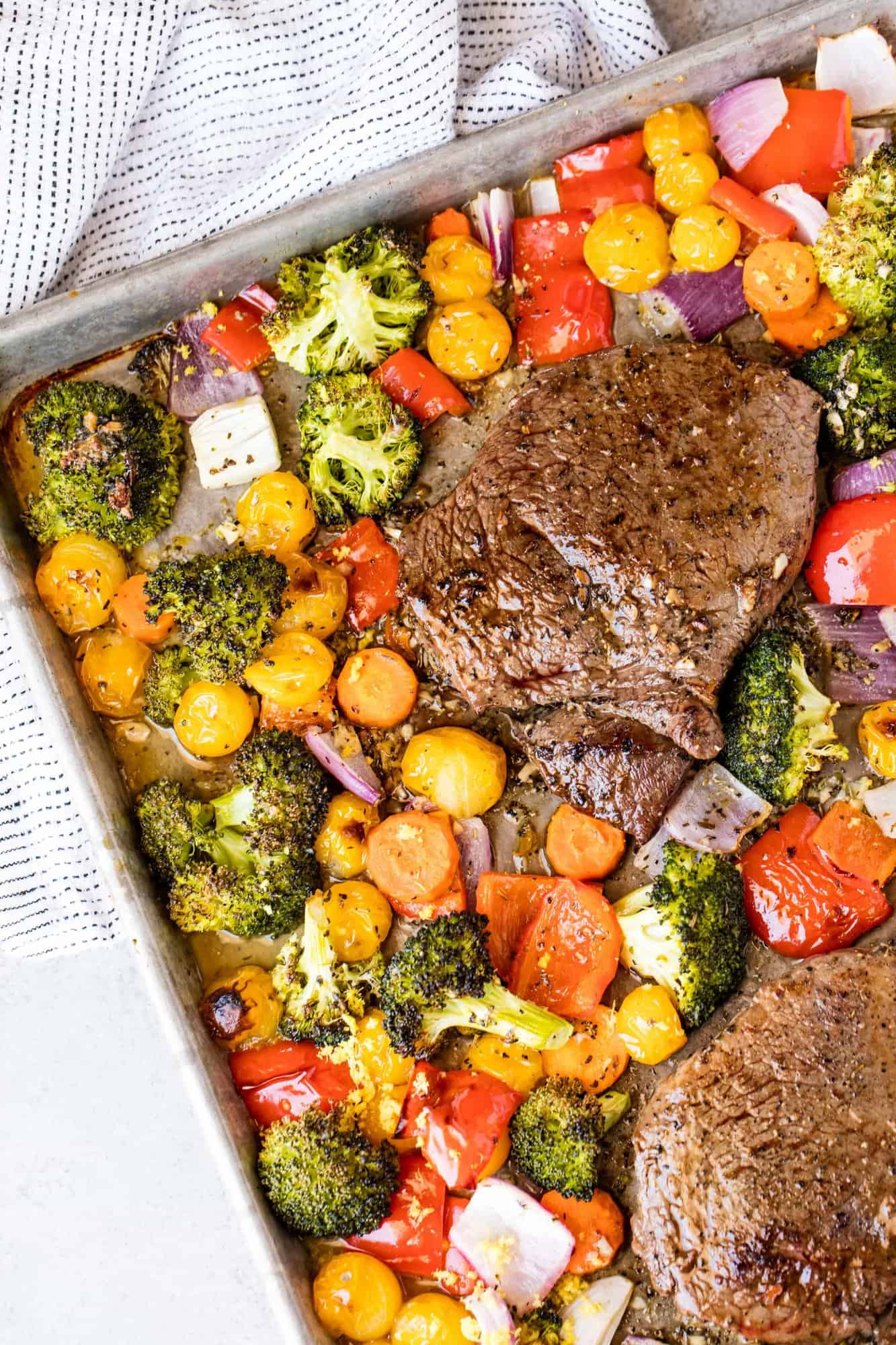 Italian Sheet Pan Steak and Veggies is a one pan meal with a colorful medley of vegetables and an Italian inspired butter sauce that keeps everything moist and flavorful.