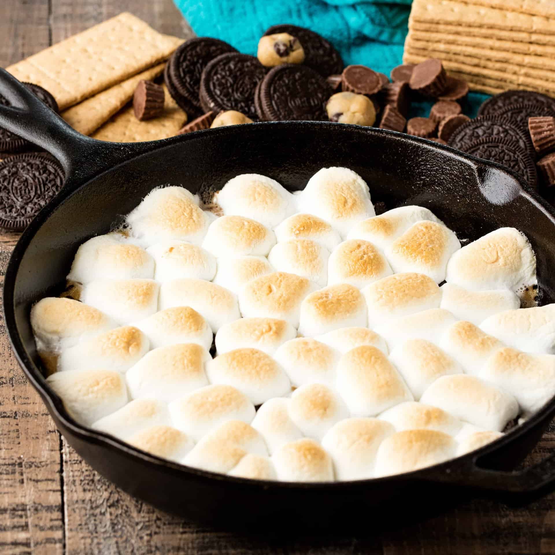 Million Dollar Skillet S'mores pack in all your favorites into one dessert: oreos, cookie dough, peanut butter cups, and s'mores! This indulgent dessert is ready in 10 minutes!