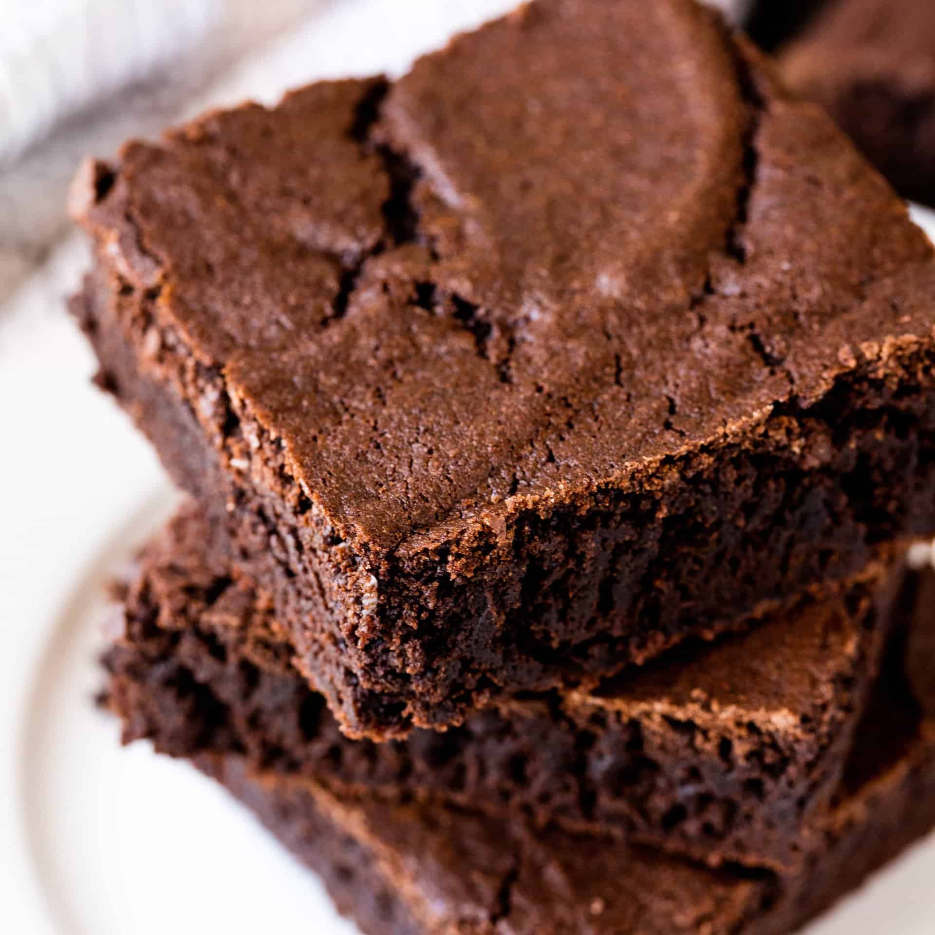 The Most Amazing Brownies are the perfect chewy fudge squares of chocolate. You'll never buy a boxed brownie mix again! You can make these brownies with either baking chocolate or cocoa powder too!