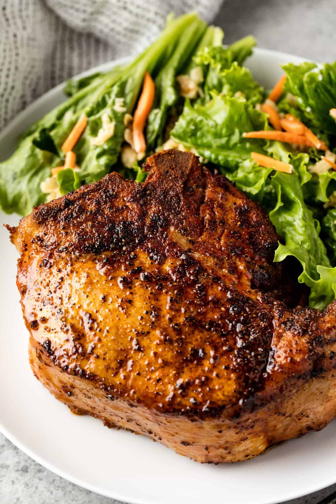 Learn how to make Smoked Pork Chops on a smoker. This recipe is perfect for beginner meat smoking and produces a juicy, smoke filled thick pork chop that is to die for!
