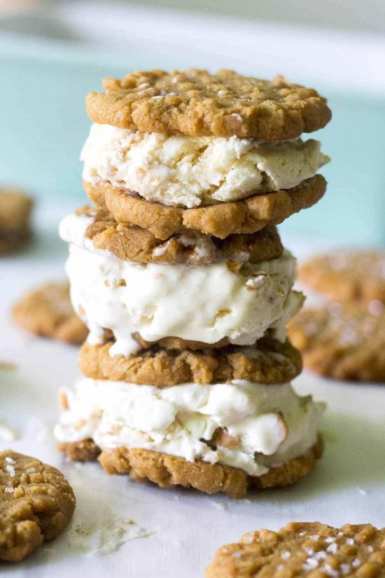 A stack of Flourless Peanut Butter Cookie Ice Cream Sandwiches on a counter