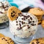 Chocolate chip cookie dough pudding in a serving dish with a cookie in it and sprinkled with chocolate chips