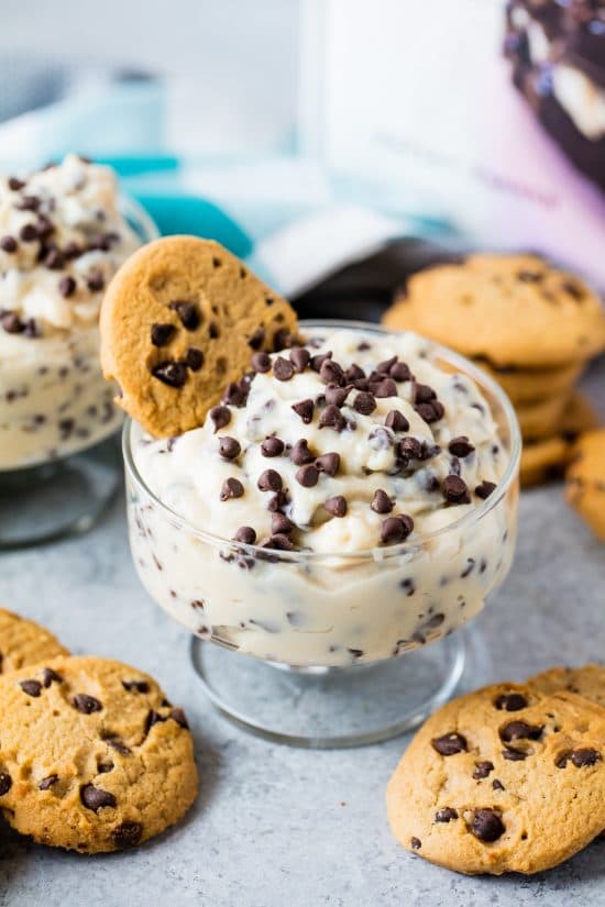 Chocolate chip cookie dough pudding in a serving dish with a cookie in it and sprinkled with chocolate chips