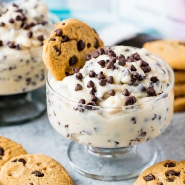 Chocolate Chip Cookie Dough Pudding in a glass bowl with a cookie in it.