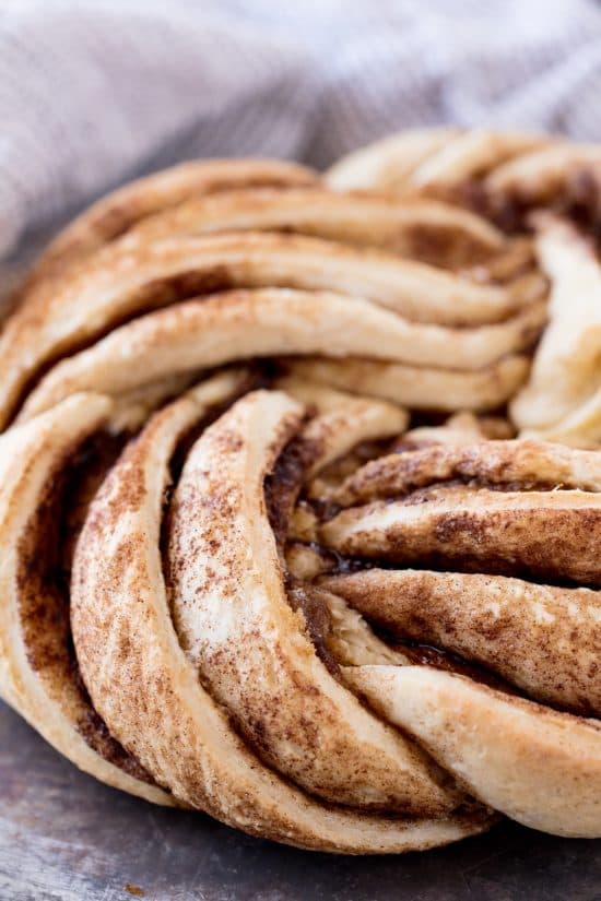 A closeup of twisted and baked cinnamon bread with cinnamon sugar layers