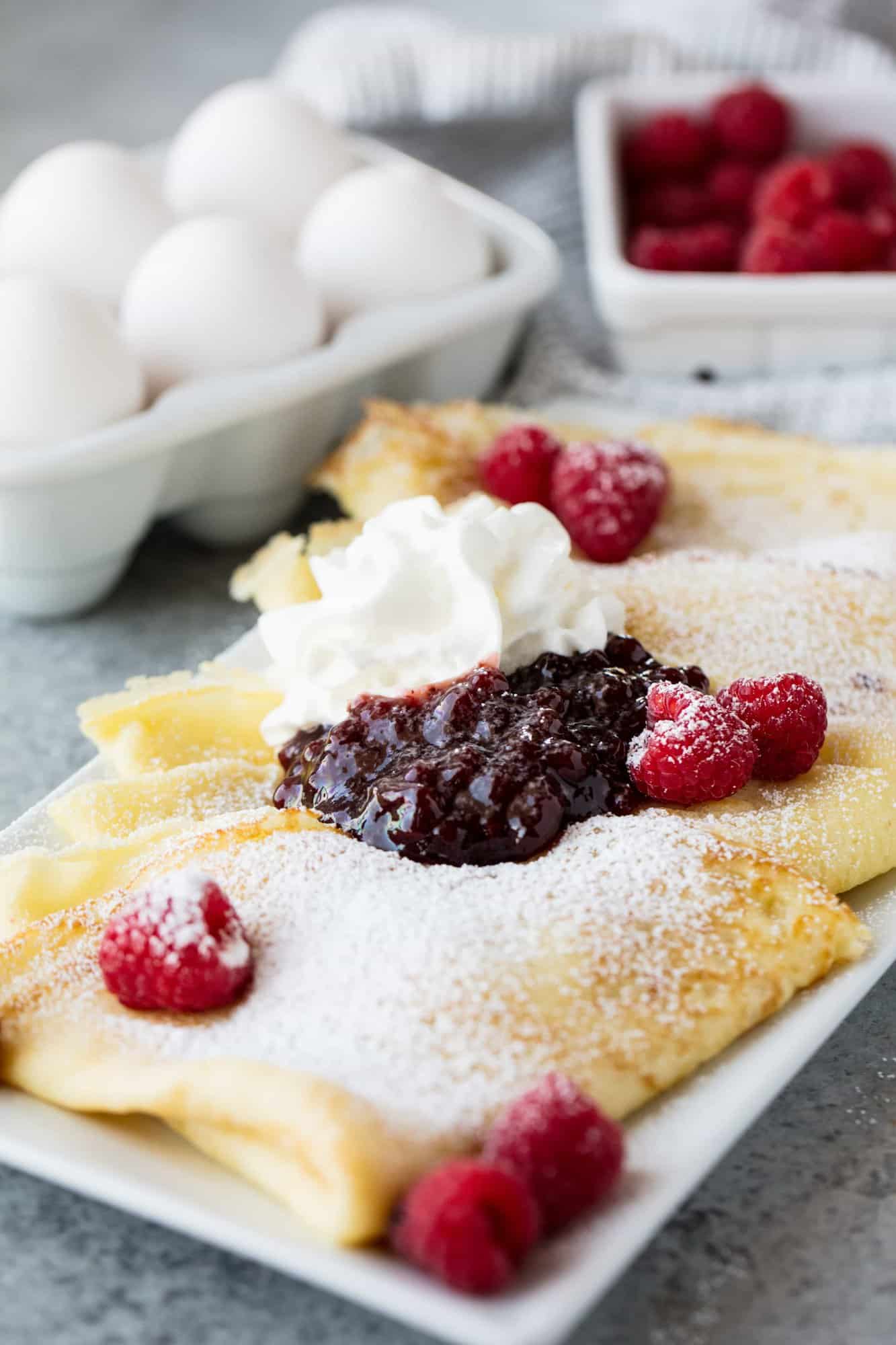 Fluffy Swedish Pancakes come together in minutes making it a fun breakfast or brunch item that the whole family will love. Dust them with a little powdered sugar and serve with fresh fruit, jam, and whipped cream!