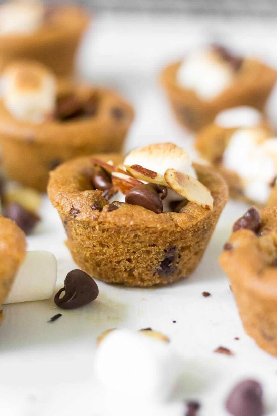 rocky road cookie cups filled with chocolate chips, slivered almonds and marshmallows