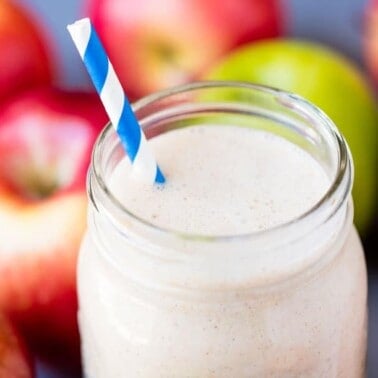Make-ahead apple pie oatmeal smoothie in a mason jar with a blue and white straw