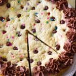 Bird's eye view of a Chocolate Chip Cookie Cake with a slice ready to be taken out.