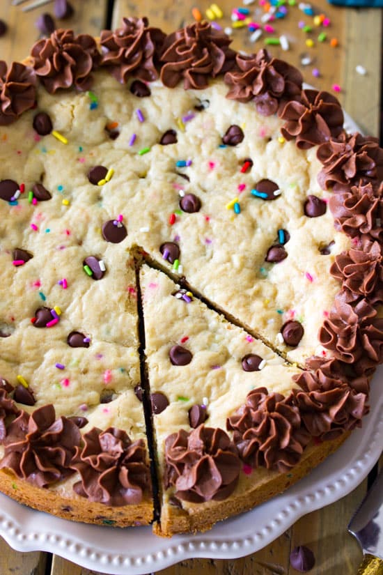 Bird's eye view of a Chocolate Chip Cookie Cake with a slice ready to be taken out.