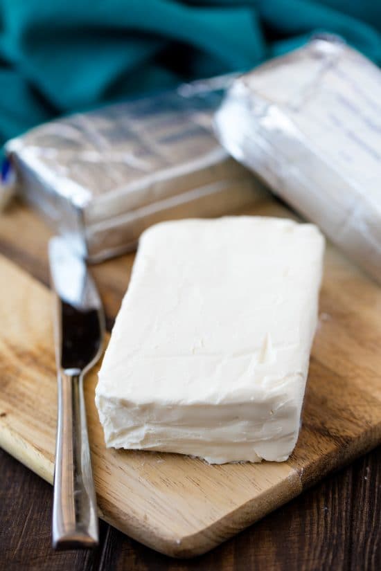 Cream cheese on a cutting board.