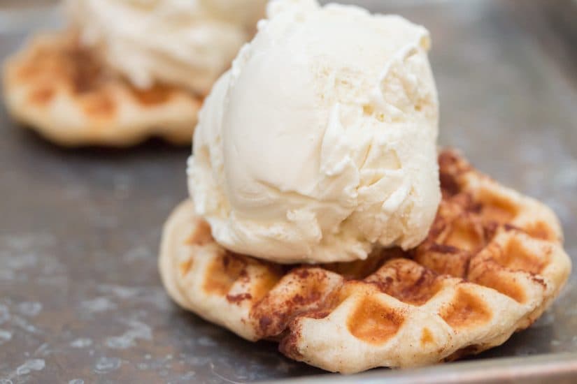 Cinnamon Roll Ice Cream Sandwiches are made in the waffle iron for a decadent Cinnamon Roll Ice Cream Sandwiches