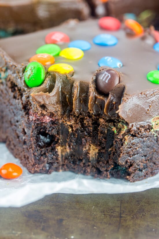 Close up of the side of a M&M Fudge Brownie with a fork bite taken out of it.