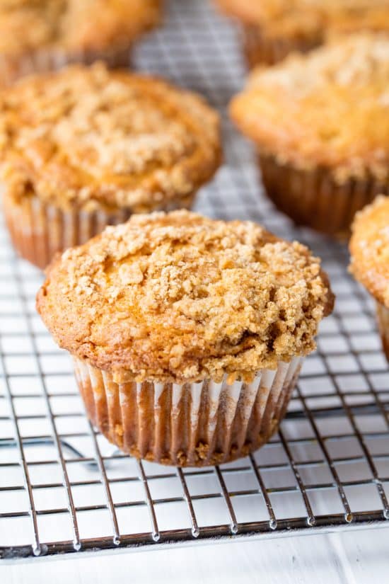 Sour Cream Coffee Cake Muffins on a wire cooling rack.