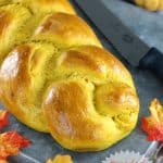 braided pumpkin bread with knife to slice