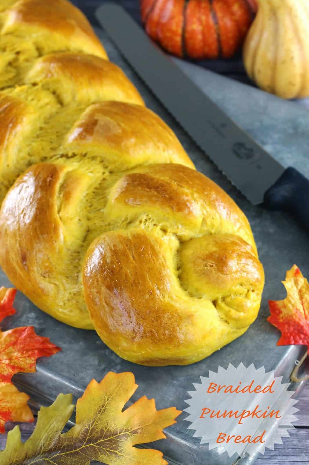 braided pumpkin bread with knife to slice