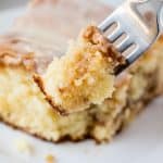 Close up of a fork with some coffee cake on it.