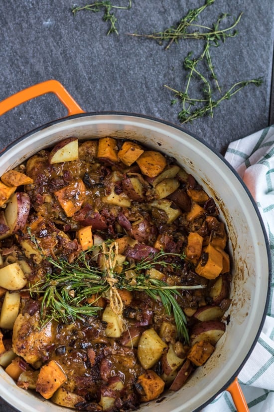 A pot of Honey Mustard BBQ Chicken garnished with fresh herbs