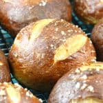 Close up of pretzel rolls cooling on a wire rack.