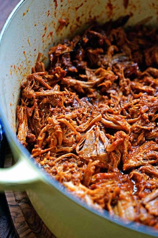 Shredded pork in a ceramic cast iron pot. 