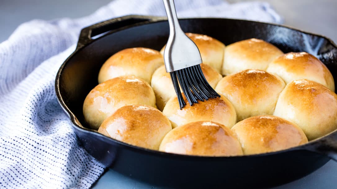 Rapid rise skillet rolls being brushed with butter