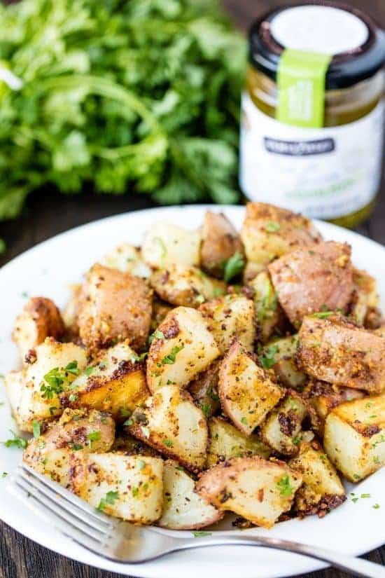 Roasted Parmesan Pesto Potatoes on a white plate.