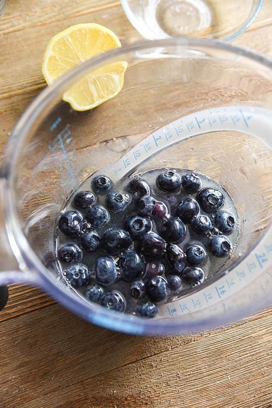 Birds eye view of a meuasring cup with 1 cup of blueberries in it. 