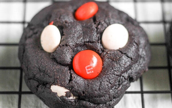 Dark chocolate halloween cookie on a cooling rack.