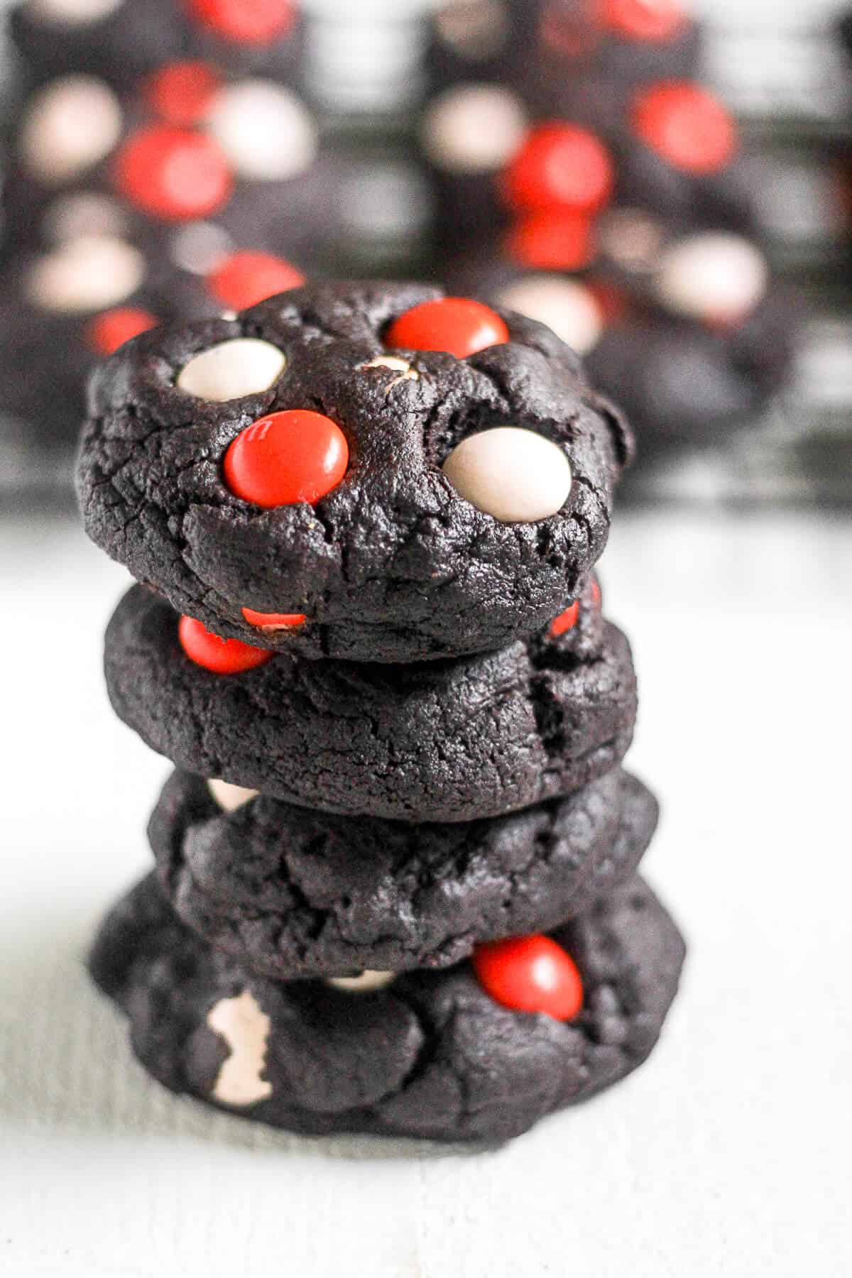 A stack of Dark Chocolate Halloween Cookies with red and white M&Ms