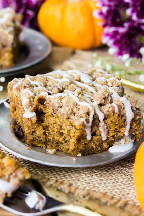This moist pumpkin crumb cake is a soft, seasonally flavored pumpkin cake infused with the best flavors of fall (think pumpkin spice, cinnamon, and real pumpkin) and topped off with a buttery cinnamon crumble topping!