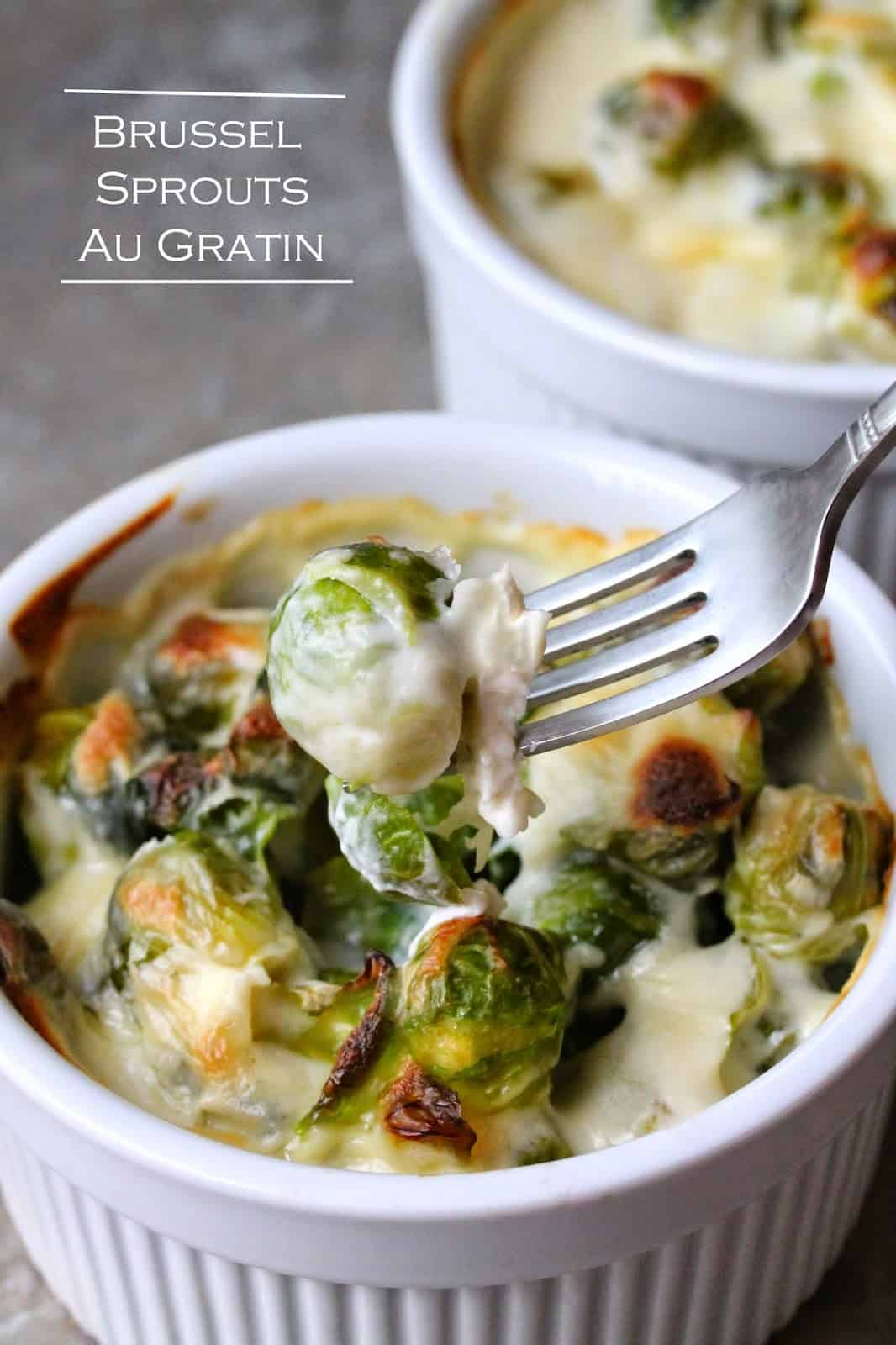 A fork lifts a bite of Brussel Sprouts Au Gratin from a bowl