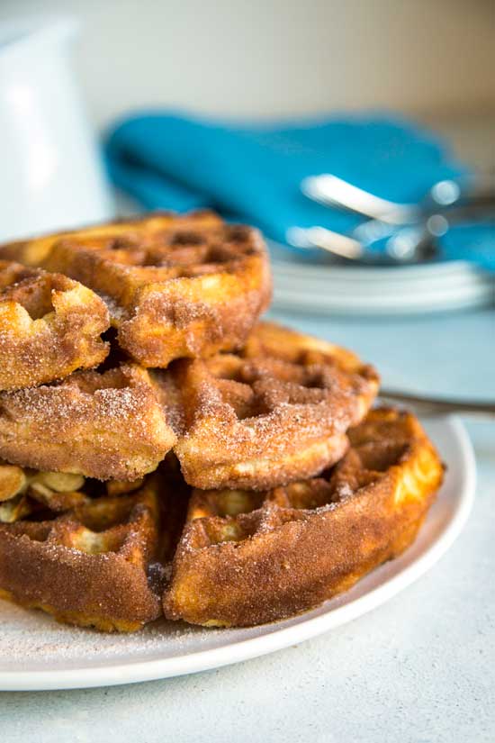 My Churro Waffles start with a fluffy, whipped batter to keep them light and after getting a cinnamon sugar dusting are topped with caramel pineapple bits. keviniscooking.com