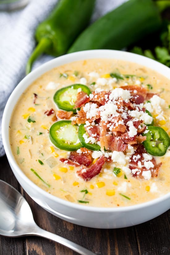 Mexican Street Corn Soup topped with sliced jalepeno, crispy bacon and cotija cheese
