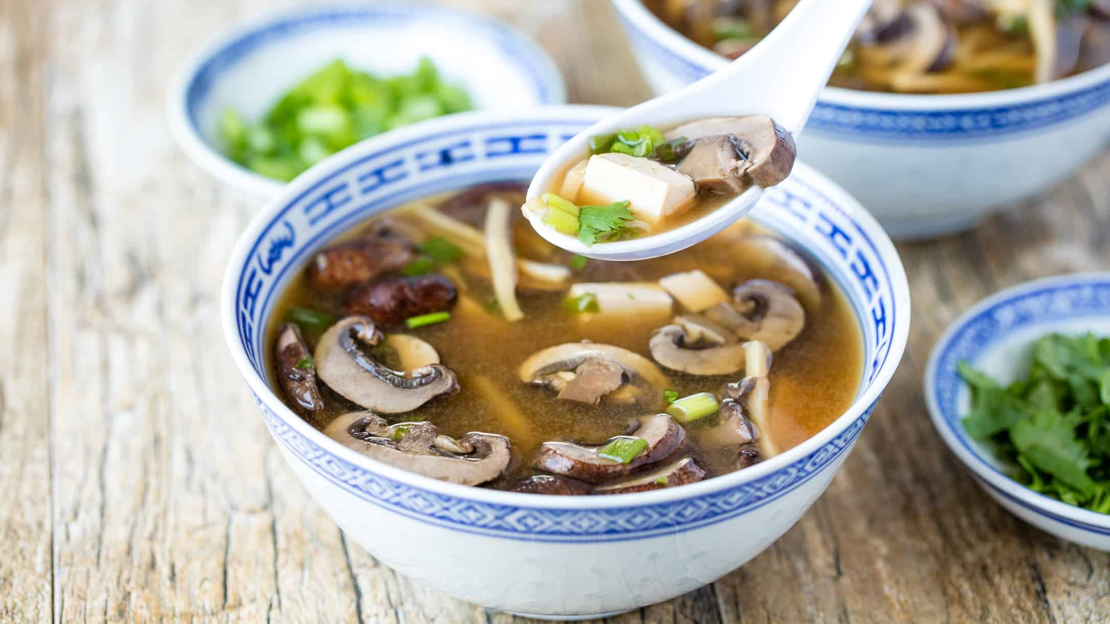 Hot and sour soup in a bowl with blue decorative trim