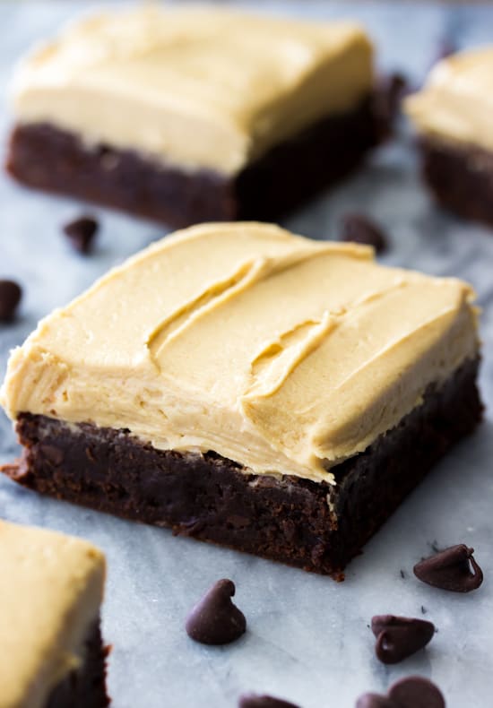 Brownies cut into squares, topped with peanut butter frosting