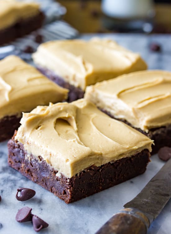 Brownies cut into squares, topped with peanut butter frosting